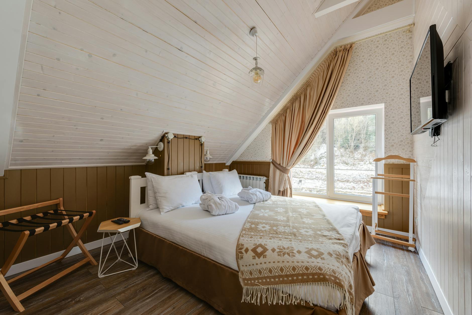 A bright attic conversion with a cozy sofa and storage solutions.