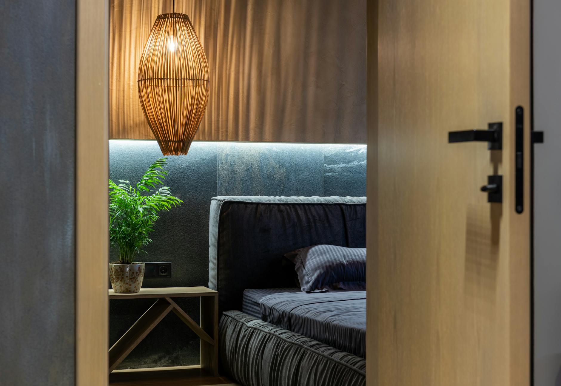 cozy L-shaped bedroom alcove with warm lighting and plants