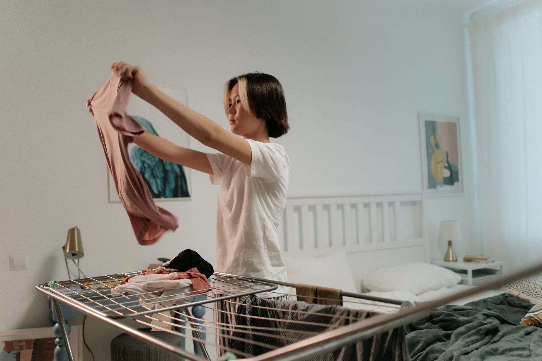A well-organized laundry room with a washer, dryer, and storage shelves.